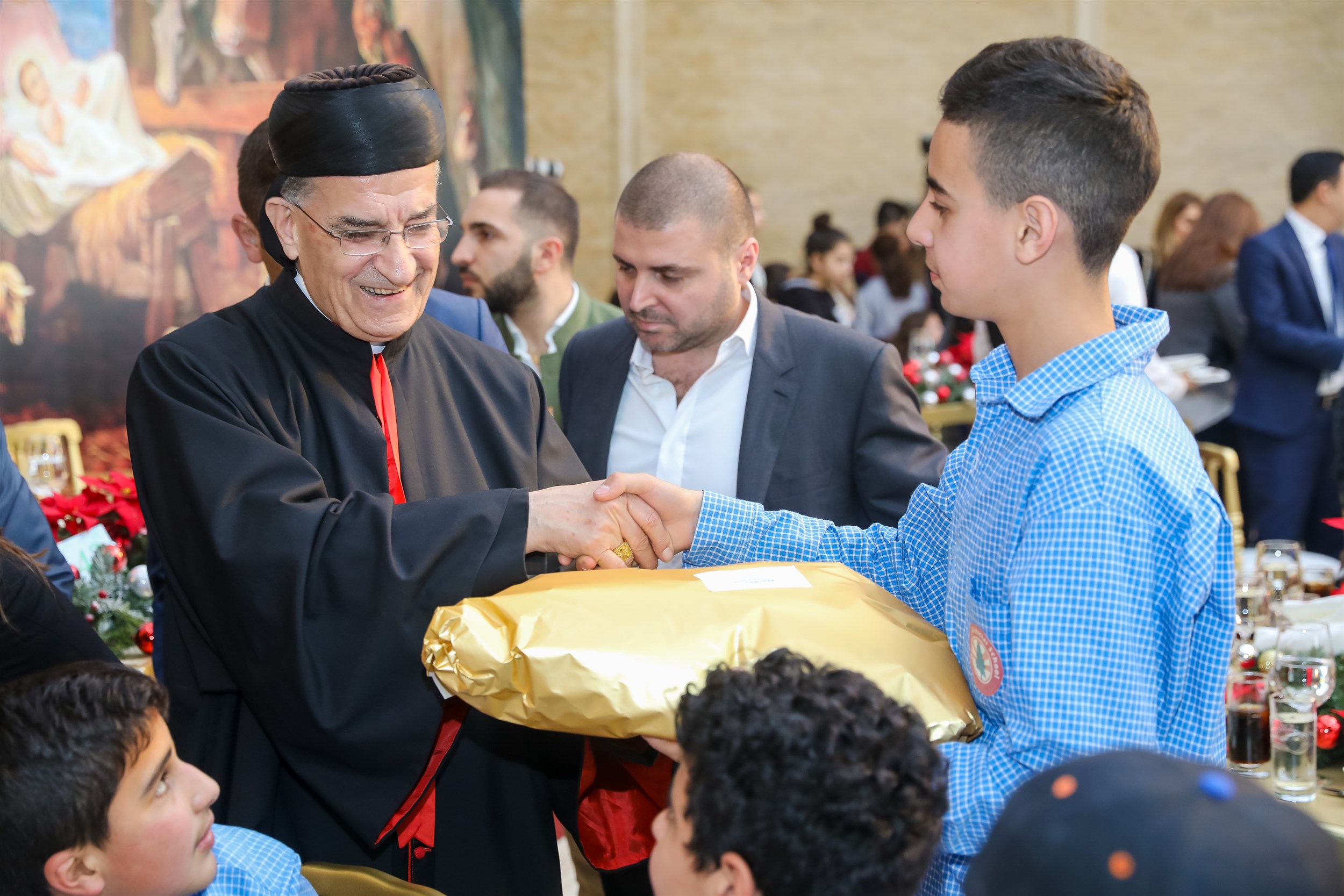 his beatitude the patriarch cardinal mar bechara boutros al-rahi distributing gifts to the children